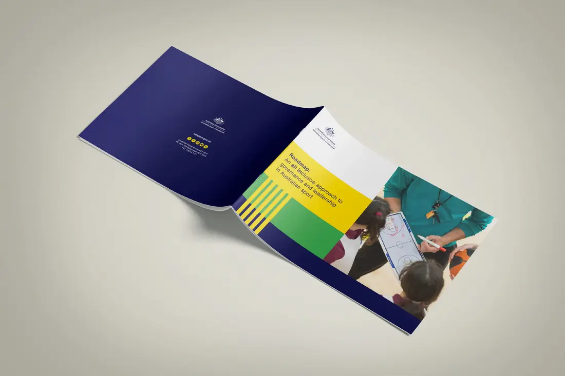 The printed Intersectionality Framework report for the Australian Sports Commission, open to show its navy cover and a colourful inside page.