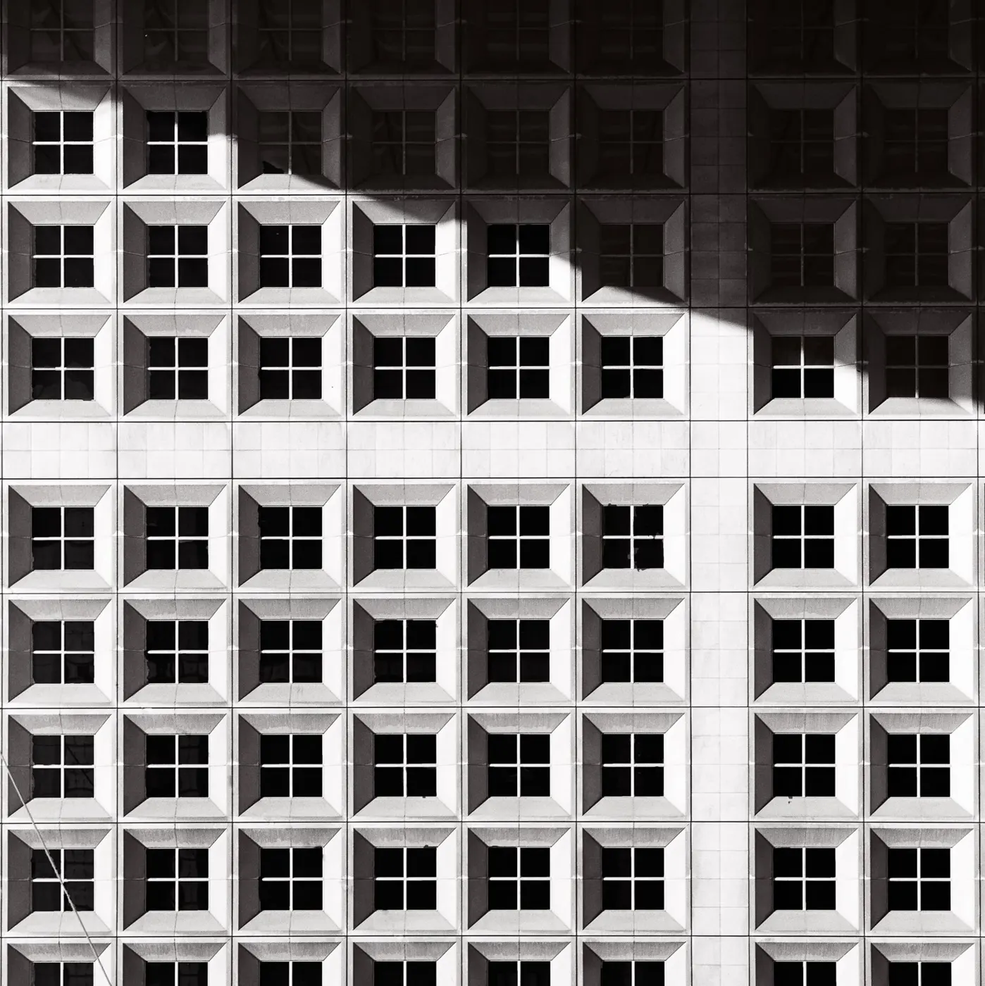 A white facade of repeating square windows